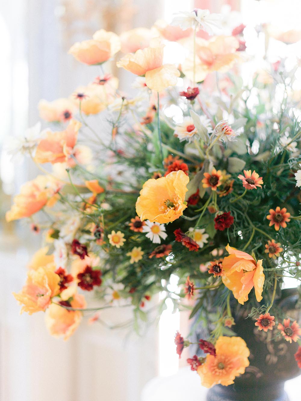Modern orange and ivory floral arrangement inside the villa